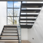 Frameless glass balustrade and staircase to house