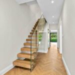 Floating staircase with frameless glass balustrade